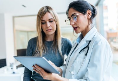 Shot,Of,Beautiful,Female,Doctor,Talking,While,Explaining,Medical,Treatment